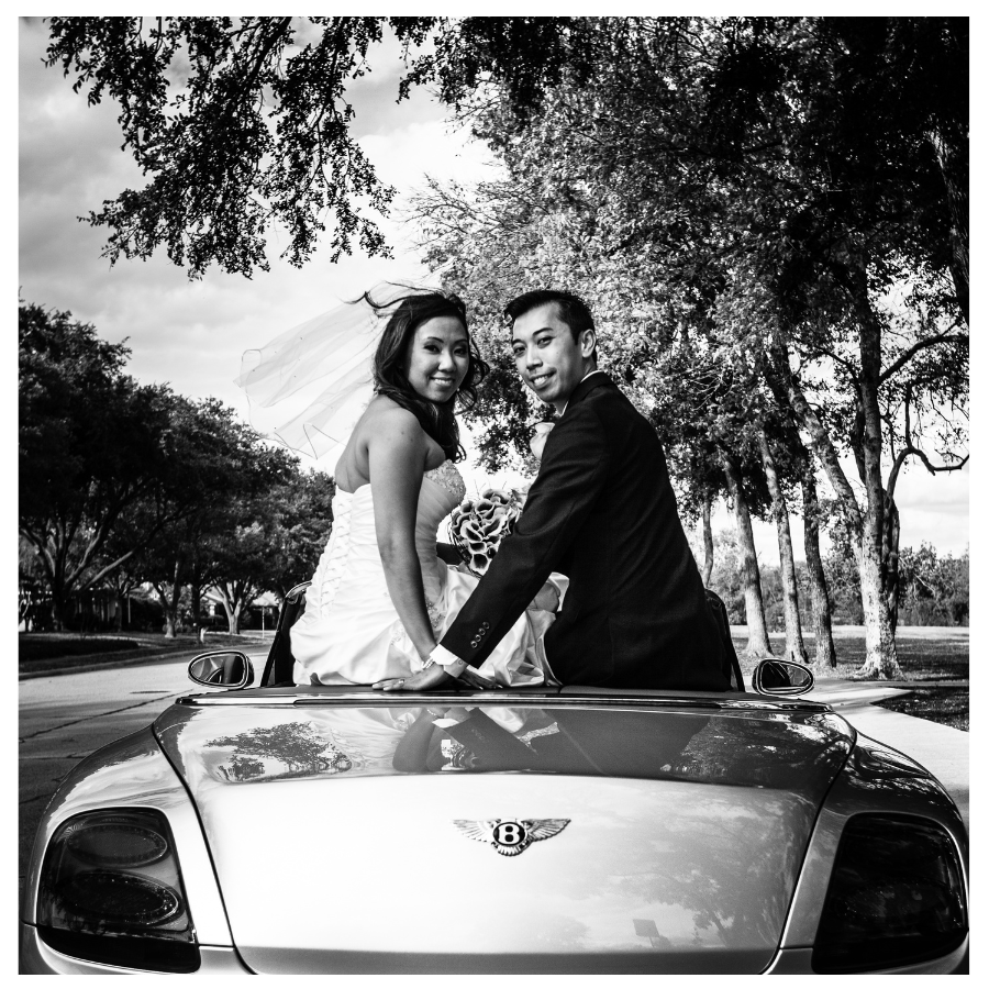 Black and white wedding portrait of a bride and groom on a convertible — the kind of photo that becomes a 3 inch square custom photo magnet